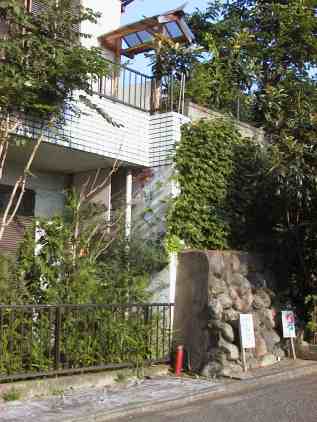 White tiled house with grey stone walls. south end of house